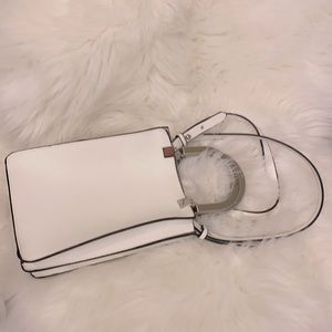 White bag with silver handles and detachable strap